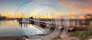 Sunrise over Naples City Dock in Naples, Florida through a crystal ball