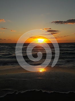 Sunrise over the ocean horizon Cancun Mexico beach sun sky clouds sunlight reflection travel tourism