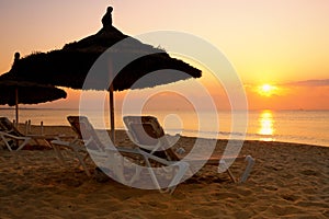 Sunrise over the parasol on the beach, Tunisia