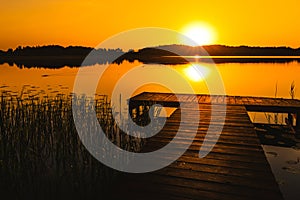 sunrise over the pier over the lake Wigry in Poland