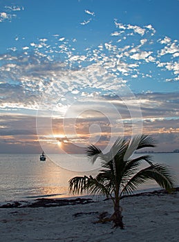 Sunrise over Puerto Juarez Bay, Beach, and fishing boat in Cancun Mexico