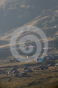 Sunrise over rice terrace with small village