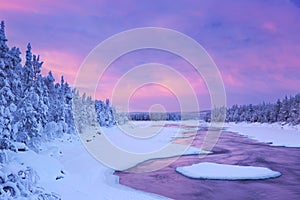 Sunrise over river rapids in a winter, Finnish Lapland