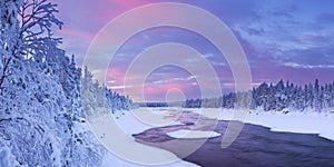 Sunrise over a river in a winter landscape, Finnish Lapland