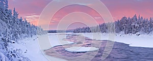 Sunrise over a river in a winter landscape, Finnish Lapland photo