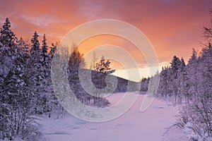 Sunrise over a river in winter near Levi, Finnish Lapland