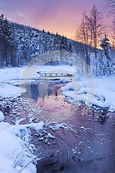 Sunrise over a river in winter near Levi, Finnish Lapland