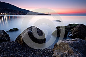 Sunrise over rocky black sea coastline