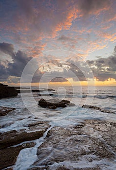 Sunrise over rocky ocean seascape - VERTICAL FORMAT