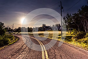 Sunrise over scenic old winding road with yellow lanes