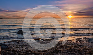 Sunrise over the sea and beautiful cloudscape. Colorful ocean beach sunrise with deep blue sky and sunrays Sunset, beach