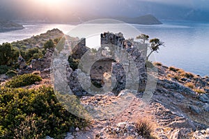 Sunrise over sea and mountains. Rocks and water senery