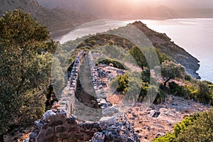 Sunrise over sea and mountains. Rocks and water senery