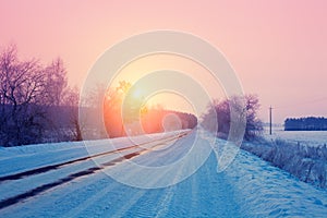 Sunrise over snowy road