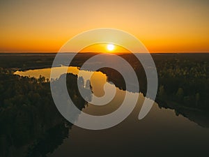 Sunrise over spring meadow. Spring aerial landscape. Spring sunrise over green forest and field with river and fog.