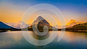 Sunrise over Swiftcurrent Lake and Grinnell Point in Glacier National Park photo