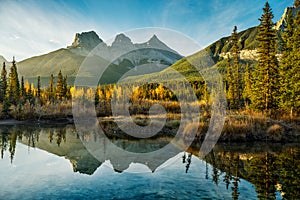 Sunrise over the Three Sisters that is reflecting in Policeman Creek