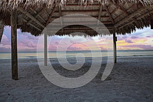 Sunrise over tiki hut on the ocean at Port Royal Beach