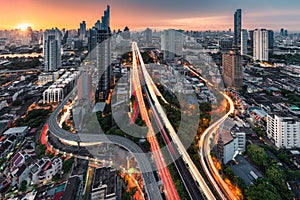 Sunrise over Trident road at Sathorn, Taksin bridge and illuminated traffic at Bangkok