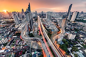 Sunrise over Trident road at Sathorn, Taksin bridge and illuminated traffic at Bangkok