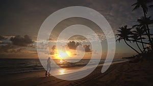 Sunrise over tropical beach in Punta Cana, Dominican Republic. Running woman.