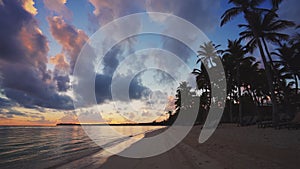 Sunrise over tropical island beach and palm trees. Punta Cana, Dominican Republic.