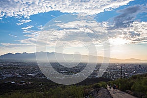 Sunrise over Tucson mountains with city in valley below