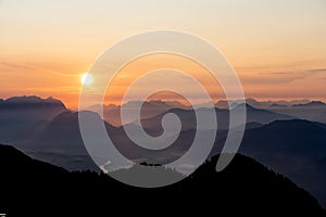 Sunrise over the tyrol alm high over the mountains scenery close up minimal silhouette