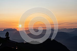 Sunrise over the tyrol alm high over the mountains scenery close up minimal silhouette