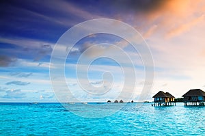 Sunrise over water bungalows in Maldives