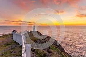 Sunrise over a white lighthouse at Cape Spear National Historic Site, St Johns Newfoundland.