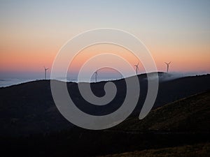 Sunrise panorama of wind turbines farm park on mountain hill top at Baloico do Trevim Lousa swing Coimbra Portugal