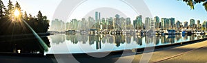 Sunrise panoramic view of Vancouver skyline as seen from Stanley Park, British Columbia, Canada