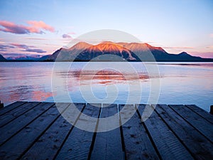 Sunrise at pier with mountains faraway