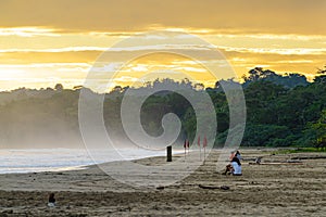 Sunrise at Playa Cocles, beautiful tropical Caribbean beach, Puerto Viejo, Costa Rica east coast, tourists meet the dawn