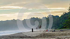 Sunrise at Playa Cocles, beautiful tropical Caribbean beach, Puerto Viejo, Costa Rica east coast, tourists meet the dawn