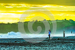 Sunrise at Playa Cocles, beautiful tropical Caribbean beach, Puerto Viejo, Costa Rica east coast, tourists meet the dawn