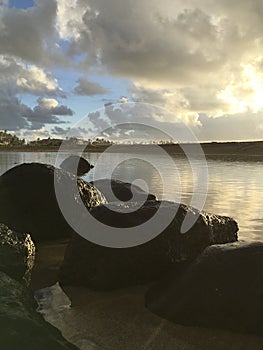 Sunrise after Rain in August in Wailua Bay between Kukui and Hikinaakala Heiaus on Kauai Island, Hawaii.