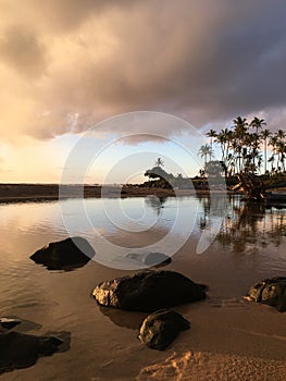 Sunrise before Rain in August in Wailua Bay between Kukui and Hikinaakala Heiaus on Kauai Island, Hawaii.