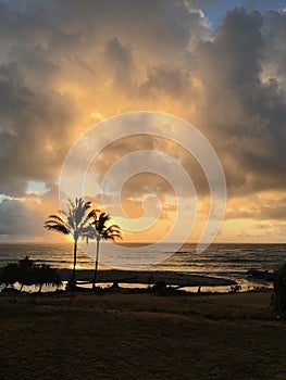 Sunrise before Rain in August in Wailua Bay between Kukui and Hikinaakala Heiaus on Kauai Island, Hawaii.