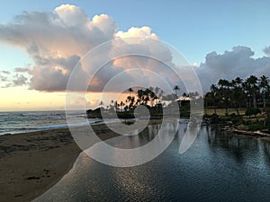 Sunrise before Rain in August in Wailua Bay between Kukui and Hikinaakala Heiaus on Kauai Island, Hawaii.