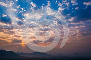 Sunrise rays on morning blue orange sky cloud with mountain landscape soft light