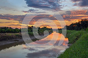 Sunrise reflection in a canal