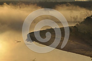 Sunrise. The river in the mist. A view of the meadows and the river in the morning