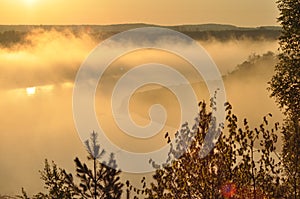 Sunrise. The river in the mist. A view of the meadows and the river in the morning