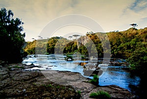 Sunrise on the River with trees and rocks photo