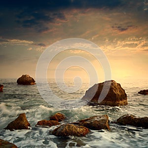 Sunrise on rocky sea coast