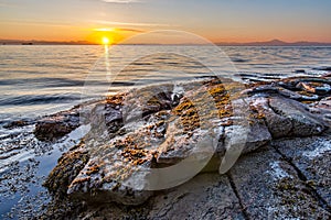 Sunrise On Rocky Shore