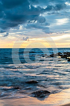 Sunrise with scattered rain clouds at the seaside