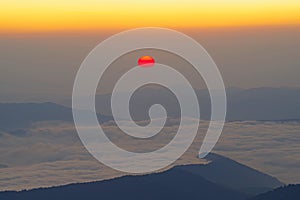 Sunrise scene with red sun over the mountains